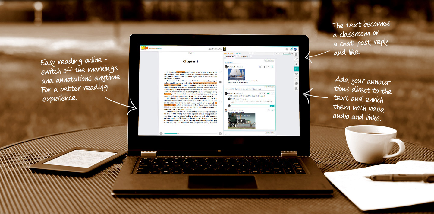 An open laptop with paper and pen and having a cofee cup and diary placed beside a laptop.
